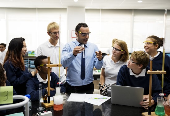 Teacher demonstrating science practical to students news7